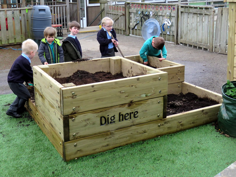 A large wooden planter for kids play area