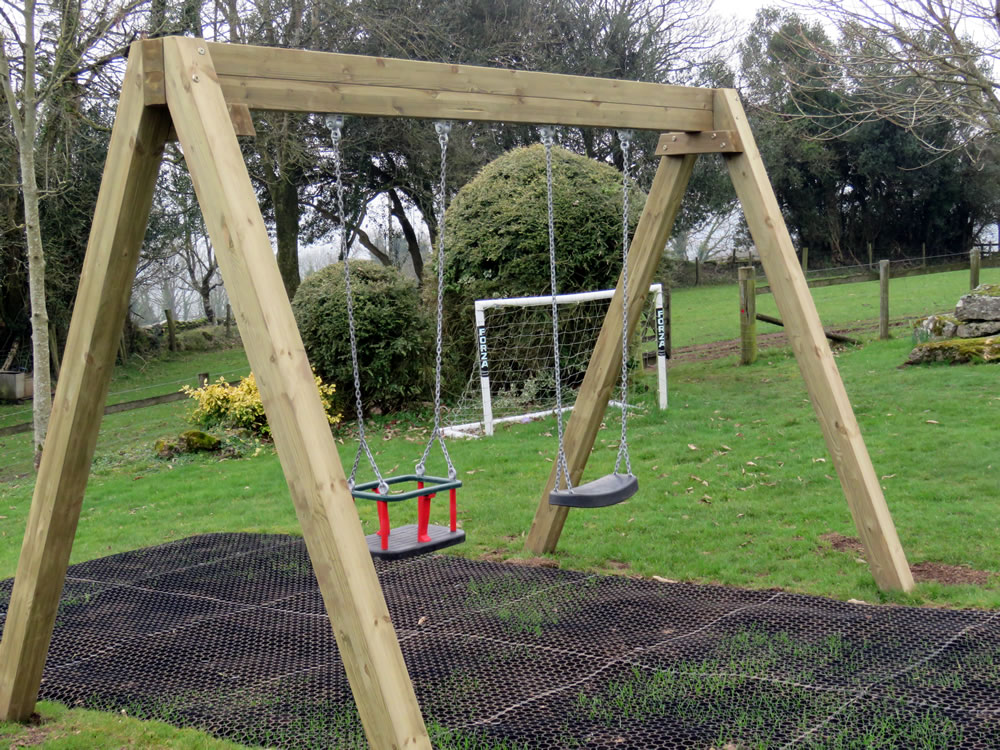 A traditional wooden swing in the play area