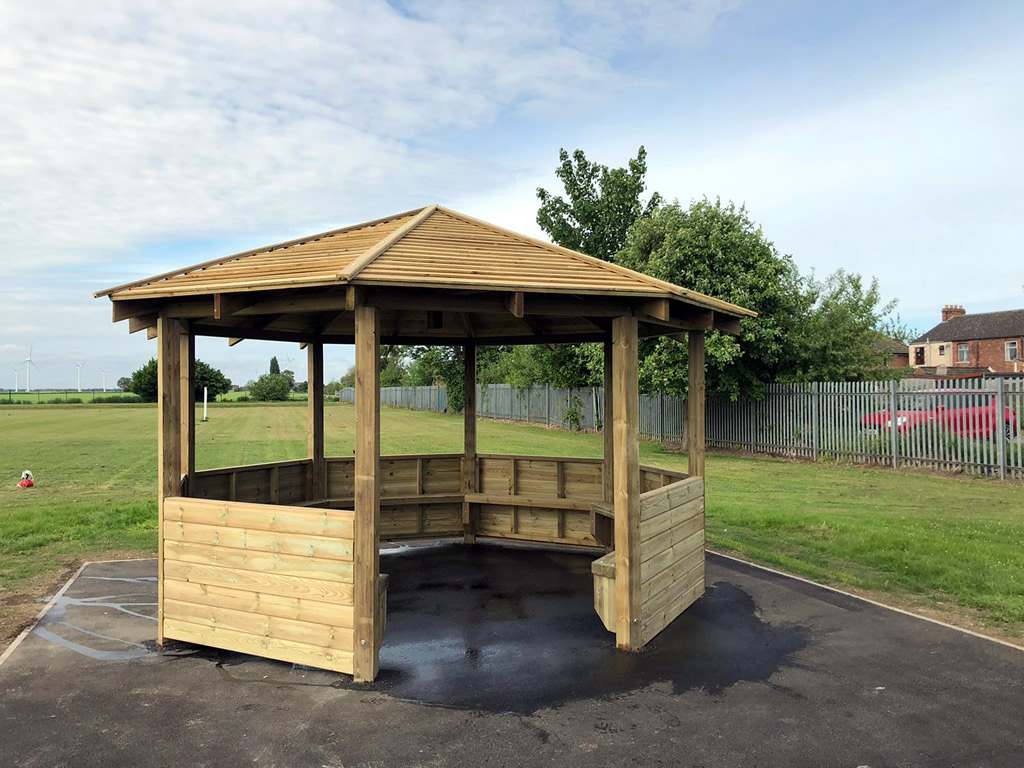 A wooden outdoor learnng shelter for children